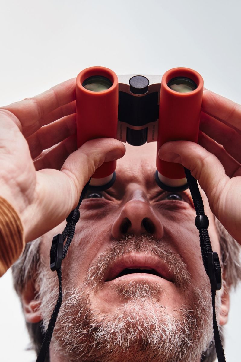 Old Male Looking Through Swarovski CL Curio Binoculars